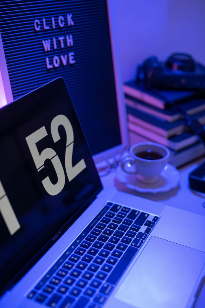 Stylish home office setup with laptop, letter board, and cup of tea.