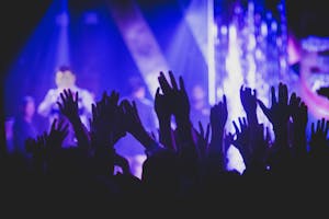 Vibrant music concert scene with crowd and colorful stage lights.