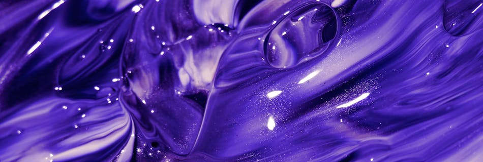 Explore the mesmerizing swirls of vivid purple paint creating a captivating abstract texture.